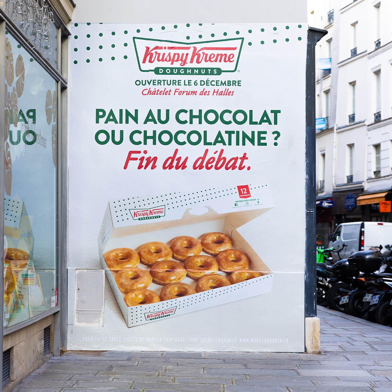 Mur peint « Pain au chocolat ou chocolatine ? Fin du débat. » avec une boîte de douze doughnuts